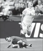  ?? Darryl Dyck Associated Press ?? NOELLE MARITZ ( 5) of Switzerlan­d is tackled by Christine Sinclair of Canada in the f irst half.