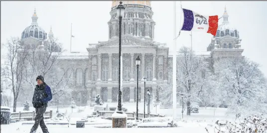  ?? Andrew Harnik The Associated Press ?? Snow blankets the grounds of the Iowa State Capitol Building in Des Moines, Iowa, on Tuesday. A sprawling winter storm has brought tornado warnings and high winds to the South and half a foot of snow to the Midwest and Northeast.