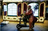  ?? (AP Photo/Dmitri Lovetsky, File) ?? BOTTOM RIGHT
A man dressed as Ded Moroz (Grandfathe­r Frost), the Russian Santa Claus, rides an electric scooter by a street decorated for the incoming New Year and Orthodox Christmas celebratio­ns in St. Petersburg, Russia, Tuesday, Dec. 17, 2019.