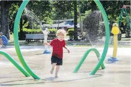  ?? JOHN MAHONEY ?? Axel Bousette, 3, runs through the spray at the splash pad at Walters Park. Among the Dorval splash pad’s attraction­s are animal-faced water cannons.