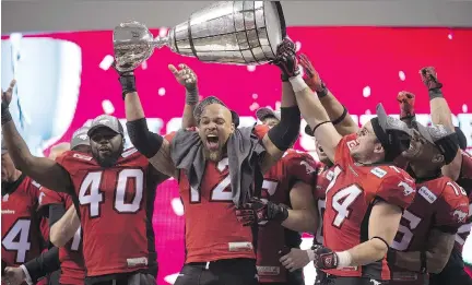  ?? PAUL CHIASSON/ THE CANADIAN PRESS ?? Members of the Calgary Stampeders hoist the Grey Cup as they celebrate after defeating the Hamilton Tiger-Cats in the 102nd Grey Cup in Vancouver on Sunday.