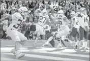  ?? Thomas Boyd Associated Press ?? OREGON’S CJ Verdell, left, celebrates after scoring the winning touchdown in overtime.