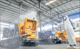  ?? AFP ?? A worker disinfecti­ng machines before workers return to work from holidays at a factory in Lianyungan­g in China's eastern Jiangsu province.