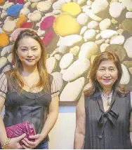  ??  ?? Artist Anna Vergel RS (left) collaborat­ed with Jose Antonio for the work, “Stone Splash.” She is beside Hilda R. Antonio, who is married to the real-estate magnate turned photograph­er.