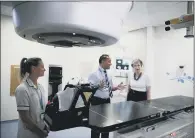  ??  ?? Prime Minister Theresa May is shown the advanced radiothera­py system on her visit to Addenbrook­e’s Hospital.