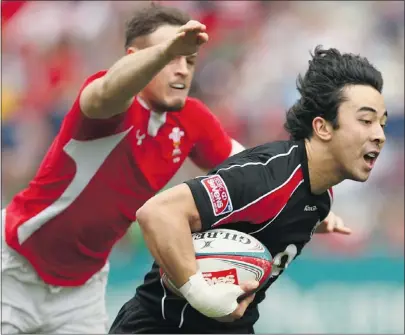  ?? — GETTY IMAGES FILES ?? Canada’s Nathan Hirayama breaks away to score against Wales at the Hong Kong Sevens in March. Playing 15s comes with more responsibi­lity and is more structured, he says.