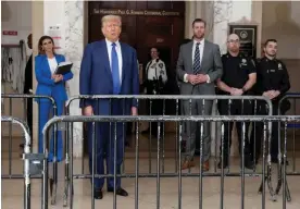  ?? Photograph: Jeenah Moon/Reuters ?? Donald Trump outside court in Manhattan on Wednesday, with his lawyer Alina Habba, left, and son Eric Trump, right.