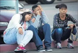  ??  ?? TEARS FALL as people grieve outside Loma Linda University Medical Center. Two of the wounded were listed in “extremely critical condition.”