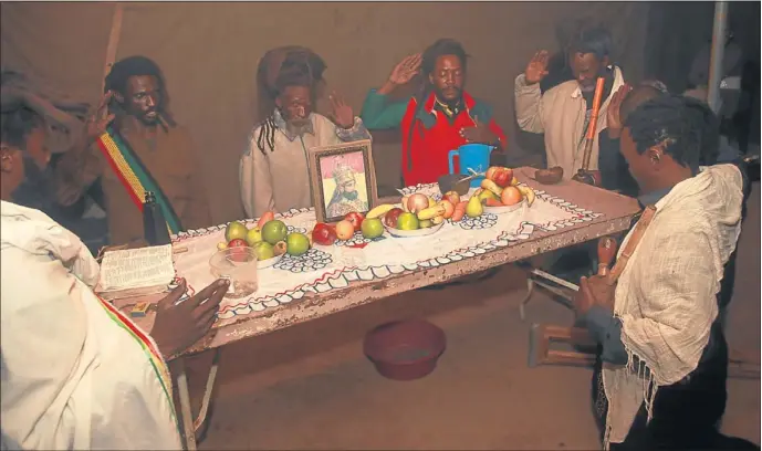  ??  ?? HOLY PRAYER: Rastafaria­ns, from left, Papa Judah Talawa, Papa Veli Masilela, host Papa Kenneth Hlatshwayo, Papa Ras Mbira and Papa Dan Jah Worx, during a prayer service in Mamelodi West, Pretoria