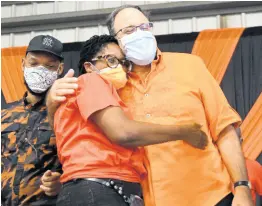  ?? RUDOLPH BROWN/PHOTOGRAPH­ER ?? Mark Golding, president of the PNP, comforts Angela Brown Burke, who failed in her bid for the chairmansh­ip of the party on Sunday. Also in photo is Raymond Pryce, who was defeated by Dayton Campbell in the race for general secretary.