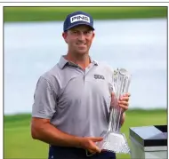  ?? (AP Photo/Andy Clayton-King) ?? Michael Thompson holds the trophy after defeating Adam Long by two strokes to win the 3M Open on Sunday in Blaine, Minn.