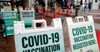  ?? Rebecca Blackwell / Associated Press ?? Dozens of people wait to be tested for COVID-19 or to be vaccinated Tuesday at a mobile health unit in Miami. Demand for rapid tests has soared while manufactur­ers are still scrambling to ramp up production.