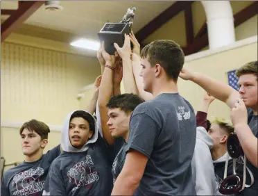  ?? OWEN MCCUE - MEDIANEWS GROUP ?? Above, Pottsgrove holds up its Border Battle trophy after Wednesday’s match against Pottstown. At left, Pottstown’s Julianna Figueroa, left, collects back points against Pottsgrove’s Christian Drager during the 120-pound match.