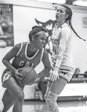  ?? JEFF FAUGHENDER/COURIER JOURNAL ?? CAL's Ava Moore fights for possession against Whitefield's Sara Ritter. Ritter scored 15 points in her team's victory Thursday.