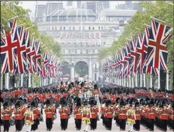  ?? TIM IRELAND/THE ASSOCIATED PRESS ?? Britain’s Queen Elizabeth II rides in a carriage among hundreds of soldiers during the Trooping the Colour parade Saturday at Buckingham Palace.