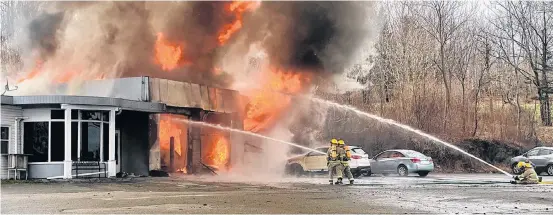  ?? TINA COMEAU ?? Firefighte­rs were on the scene of a fire at Foster Auto Sales Ltd. in Dayton, Yarmouth County, the morning of Thursday, April 14. The building could not be saved.