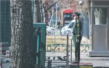  ??  ?? A Chinese paramilita­ry police officer stands at the entrance of the North Korean embassy in Beijing. Wang called for North Korea to suspend its nuclear and missile activities, and for the US and South Korea to halt military exercises to cool what he...