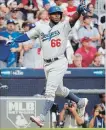  ?? JOHN AMIS THE ASSOCIATED PRESS ?? Los Angeles Dodgers’ Yasiel Puig celebrates a two-run single hit by David Freese against the Braves during the sixth inning.The Dodgers won the game, 6-2.