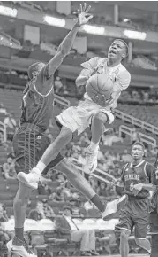  ?? Michael Ciaglo / Houston Chronicle ?? TSU guard Demontrae Jefferson (3) takes it to the basket against Grambling State’s Ervin Mitchell.