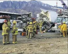  ?? KMIR-TV via AP ?? The scene of a crash between a tour bus and a semi-truck Sunday on Interstate 10 near Desert Hot Springs, near Palm Springs, is shown in California’s Mojave Desert.