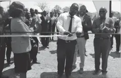  ??  ?? Masvingo provincial epidemiolo­gy and diseases control officer Dr Tapera Saravoye cuts the ribbon to mark the commission­ing of a borehole at Neshuro District Hospital in Mwenezi last Friday. Looking on (from left) is POSB general manager operations Ms...