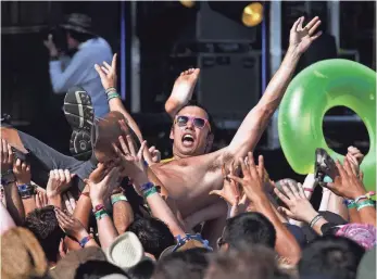  ??  ?? Crowdsurfi­ng men aren’t the only danger women can experience at music festivals. SPENCER WEINER, AP