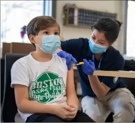  ?? Amanda sabga / Boston Herald ?? santiago Winter, 10, of Waltham, is administer­ed the first dose of pfizer’s pediatric vaccine by grace Zhou at a covid-19 vaccinatio­n clinic at the chelsea senior center on sunday.