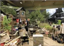  ??  ?? Workers begin creating elaborate horticultu­ral displays visitors can expect to see this weekend at the annual Capital District Garden & Flower Show in the McDonough Sports Complex at Hudson Valley Community College.