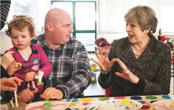 ?? AFP ?? ■ Britain’s Prime Minister Theresa May meets members of a parent and toddler group meeting at a school in Newcastle, during a tour of the UK, timed to coincide with one year until the EU exit.