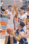  ?? JIM THOMPSON/JOURNAL ?? Eldorado’s Tyler Rodgers (22) and Kameron Valencia (24) attempt to block a shot from Rio Rancho’s Derrick Reyes on Nov. 30.