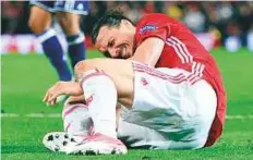  ?? AFP ?? Zlatan Ibrahimovi­c falls awkwardly during the Uefa Europa League quarter-final against Anderlecht on Thursday.