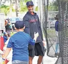  ?? ?? Triston McKenzie gets a handshake from a young player at his baseball camp in Royal Palm Beach on Saturday.