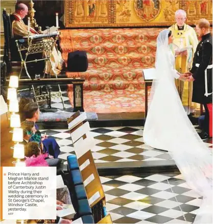  ?? AFP ?? Prince Harry and Meghan Markle stand before Archbishop of Canterbury Justin Welby during their wedding ceremony in St George’s Chapel, Windsor Castle, yesterday.