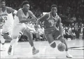  ?? ASSOCIATED PRESS ?? UCLA GUARD AARON HOLIDAY (3) drives to the basket past Arizona’s Allonzo Trier during the first half of Thursday’s game in Tucson.