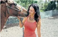  ?? Meredith Zimmerman, © The New York Times Co. ?? Jennifer Olah, owner of the equestrian nonprofit Cruzan Cowgirls, with a rescued horse on St. Croix, U.S. Virgin Islands, on March 3.