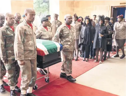  ?? Picture: AFP ?? FALLEN. South African military pallbearer­s carry the coffin of South African Defence Forces Lance Corporal Thabang Semono, who was killed during a mortar incident in Democratic Republic of Congo, as his wife, centre, attends the funeral in Pretoria on 2 March.