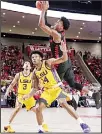  ?? (AP) ?? Houston guard Nate Hinton (11) puts up a shot over LSU guard Marlon Taylor (14) as LSU guard Tremont Waters (3) looks on during the first half of an NCAA college basketball game on Dec 12 in Houston.