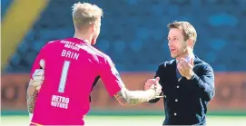  ?? Picture: SNS. ?? Neil McCann has impressed keeper Scott Bain since he came in as interim boss at Dens Park.