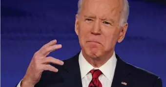  ??  ?? ‘NATIONAL CRISIS’: Former Vice President Joe Biden responds to a question during a debate with Vermont Sen. Bernie Sanders on Sunday night.