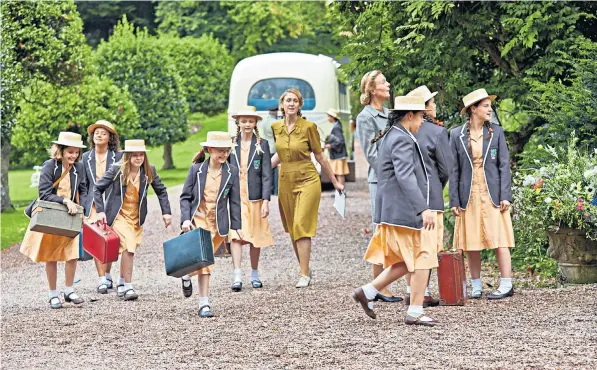  ??  ?? A sense of excitement is in the air on the first day of term as the girls arrive at MaloryTowe­rs, the school made famous by Enid Blyton, right, and centrepiec­e of the new BBC children’s drama