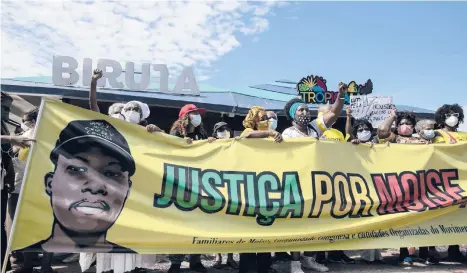  ?? BRUNA PRADO/AP ?? Protest in Brazil: Demonstrat­ors gather Saturday at a beach in Rio de Janeiro to protest the Jan. 24 death of a Congolese immigrant. Security camera footage released by police showed three men beating Moise Mugenyi Kabagambe with a rod for almost 15 minutes and even after he loses consciousn­ess. Protests were held in other Brazilian cities.