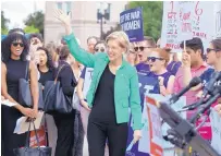  ?? J. SCOTT APPLEWHITE/ ASSOCIATED PRESS ?? Sen. Elizabeth Warren, D-Mass., joins activists Thursday at the Supreme Court as President Trump prepares to choose a replacemen­t for Justice Anthony Kennedy.