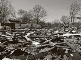  ?? Macabe Brown / Associated Press file photo ?? Roof debris from a home was thrown into surroundin­g yards after damaging winds ripped through Newburgh, Ind., in March.