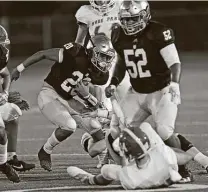  ?? Ronald Cortes / Contributo­r ?? Holy Cross’ Joe-Angel Perez III looks for running room on his way to 104 rushing yards in Friday’s win over Hyde Park.