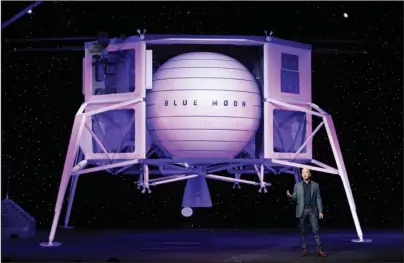  ?? The Associated Press ?? BLUE MOON: Jeff Bezos speaks in front of a model of Blue Origin’s Blue Moon lunar lander on May 9 in Washington. Bezos and Virgin Galactic’s Richard Branson favor going back to the moon before Mars. SpaceX’s Elon Musk also is rooting for the moon, although his heart’s on Mars.