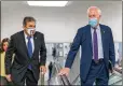  ?? ASSOCIATED PRESS ?? Sen. Joe Manchin, D-W.Va. (left), and Sen. John Cornyn, R-Texas, head to the chamber as the Senate steered toward a voting marathon on the Democrats’ $1.9 trillion COVID-19 relief bill that’s expected to end with the chamber’s approval of the measure.