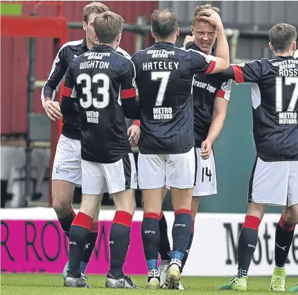  ?? Pictures: SNS Group. ?? Above: Mark O’Hara is congratula­ted by his Dundee team-mates after netting the opening goal; right: striker Marcus Haber battles with Well’s Carl McHugh; below: Dark Blues defender Kevin Gomis sees off the threat of Kevin Bowman.