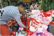  ?? ?? Vendors arrange flowers for sale on Valentine’s Day in Phnom Penh.