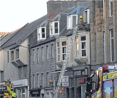  ?? Pictures: Stuart Cowper. ?? Firefighte­rs at the scene of last night’s fire in South Street. No one was hurt in the incident.