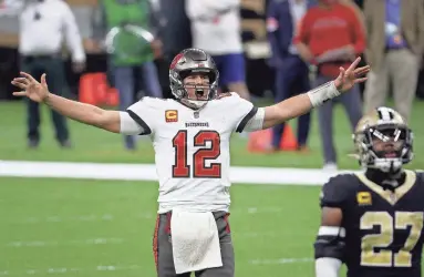  ?? GETTY IMAGES ?? Tom Brady (12) of the Tampa Bay Buccaneers celebrates a first down against the New Orleans Saints late in the fourth quarter Sunday.